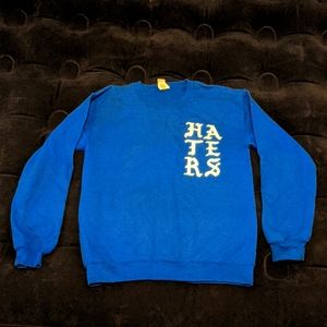 Small blue "Pray for my haters" crewneck with praying skeleton hands. Gildan.